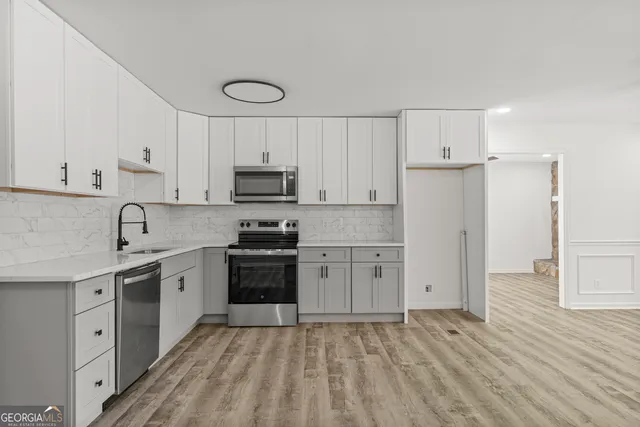 a kitchen with appliances cabinets and a sink