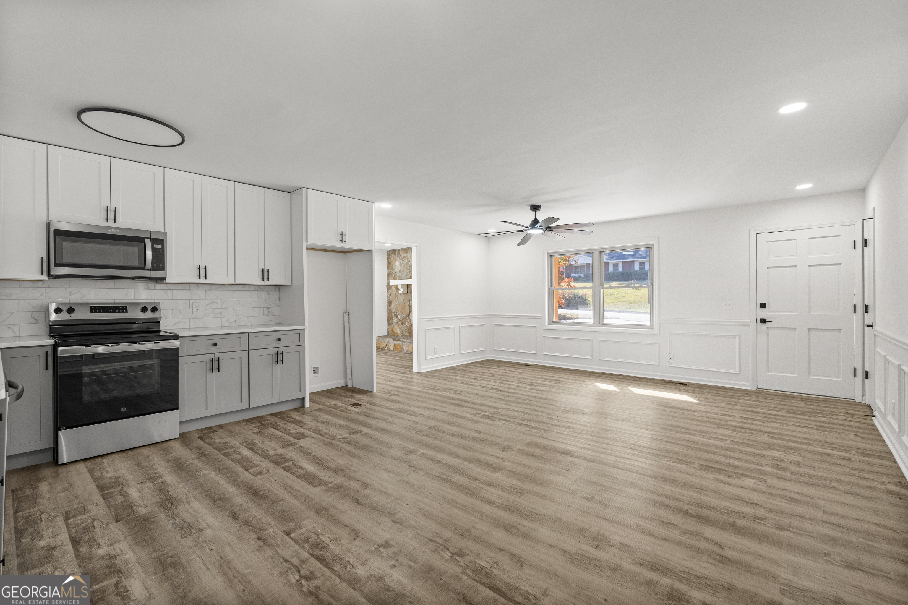 4903 Chapman Street Columbus, GA 31907 - Photo 12 of 19 a kitchen with granite countertop a stove and a refrigerator