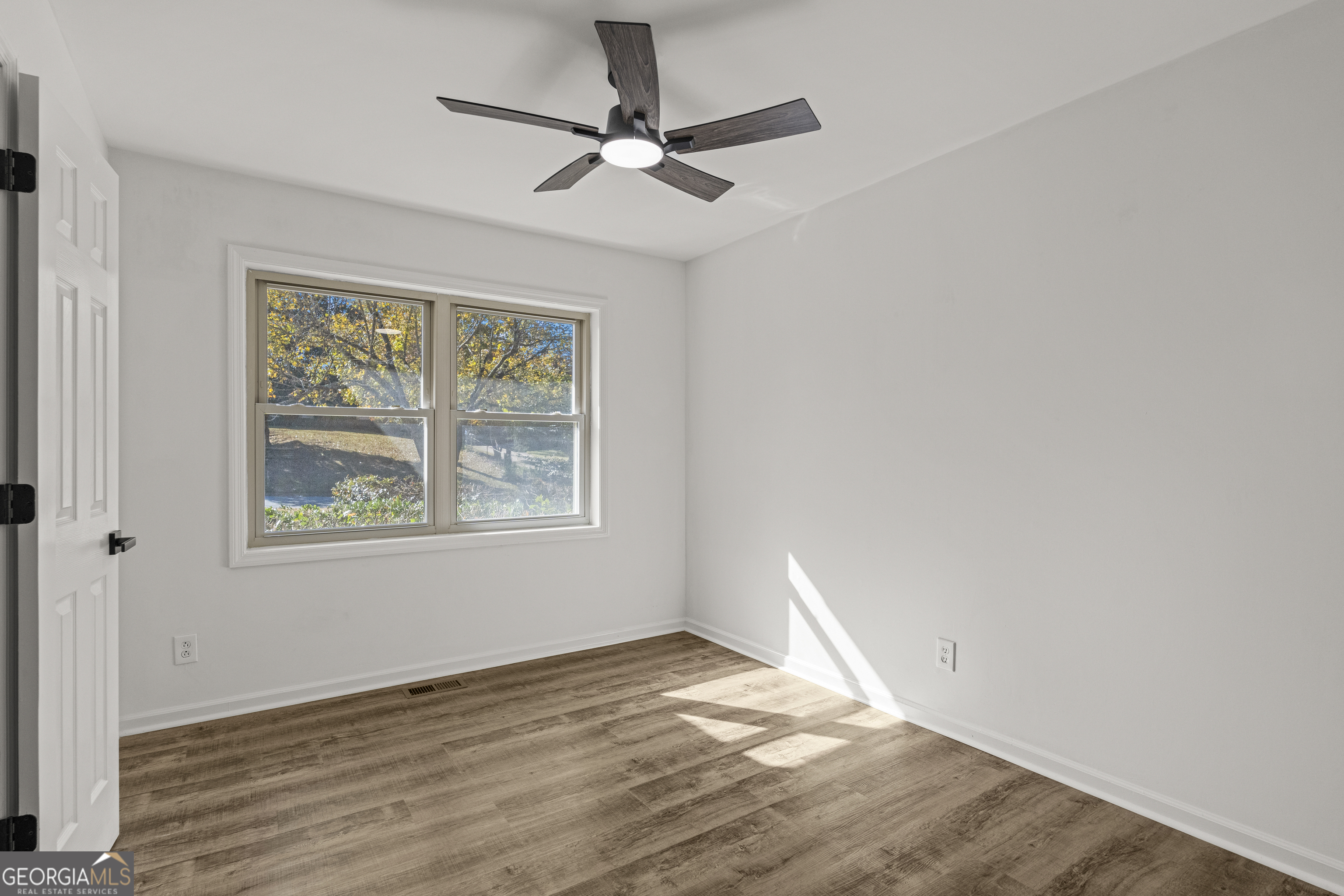 4903 Chapman Street Columbus, GA 31907 - Photo 17 of 19 a view of empty room with wooden floor and fan