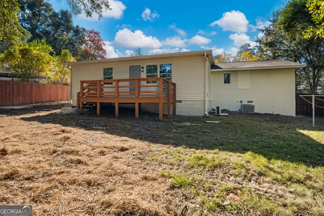a backyard of a house with table and chairs
