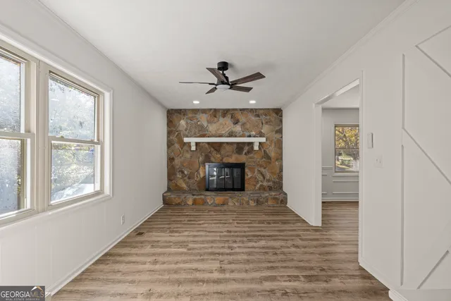 a view of a livingroom with a fireplace and window