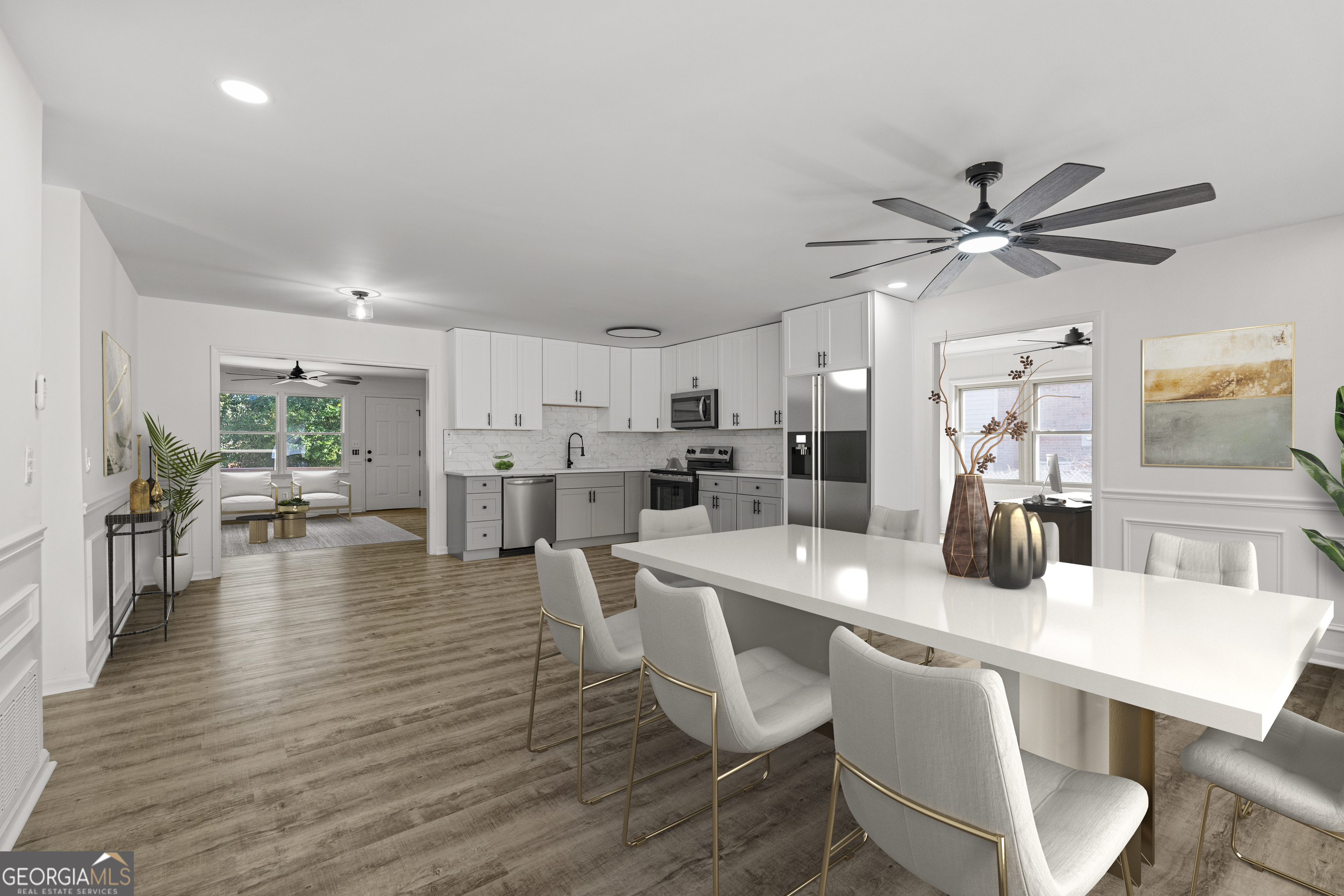 4903 Chapman Street Columbus, GA 31907 - Photo 5 of 19 a kitchen with stainless steel appliances a dining table chairs and couches with wooden floor
