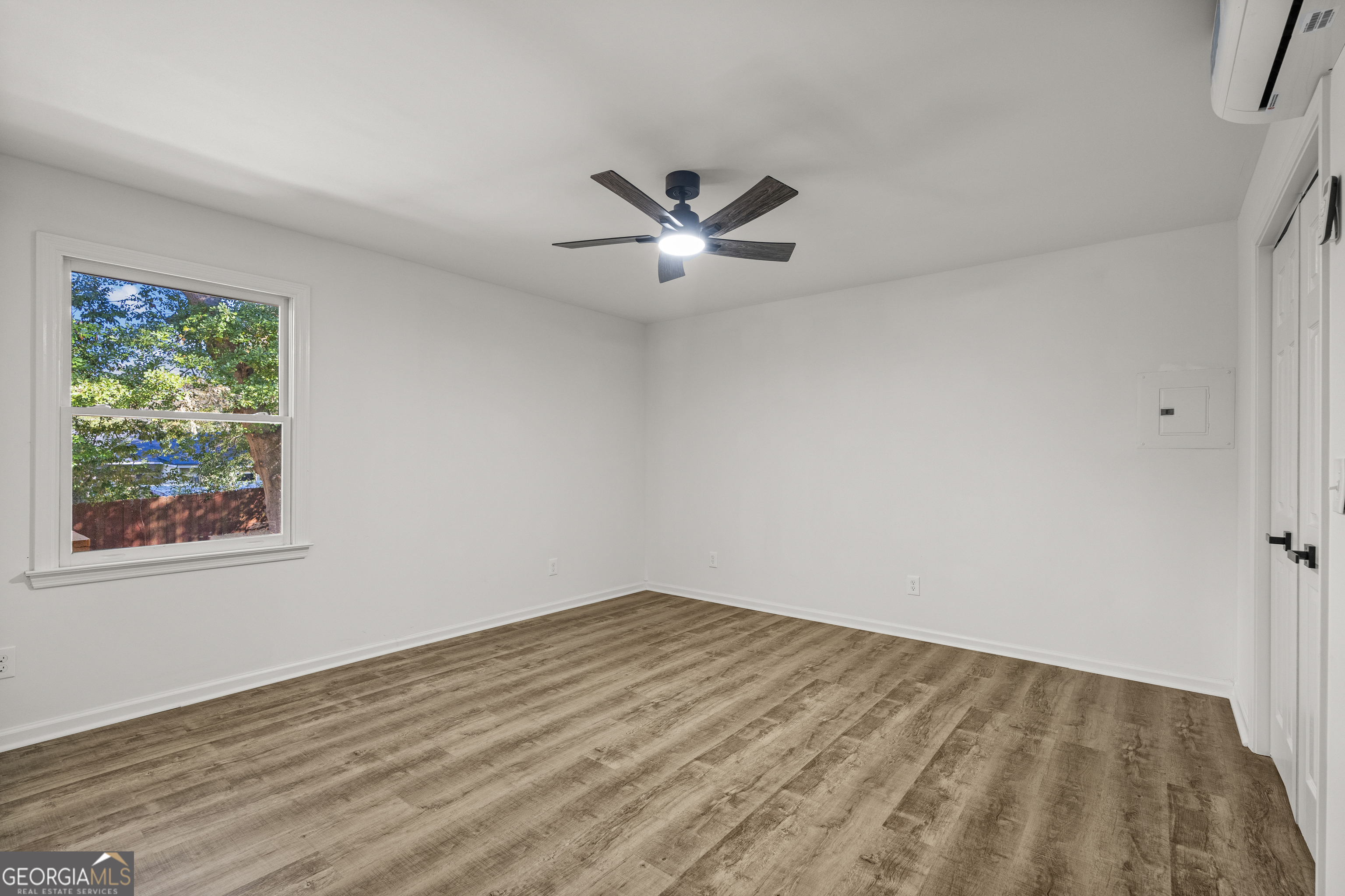 4903 Chapman Street Columbus, GA 31907 - Photo 8 of 19 an empty room with a window and a ceiling fan