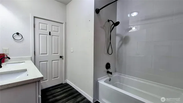 a bathroom with a tub and a shower