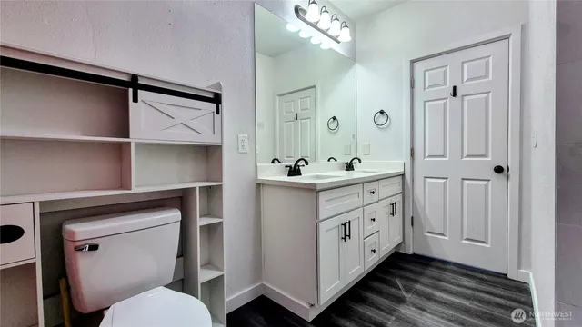 a bathroom with a double vanity sink and mirror