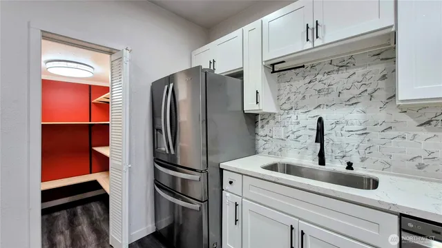 a kitchen with stainless steel appliances a refrigerator and a sink