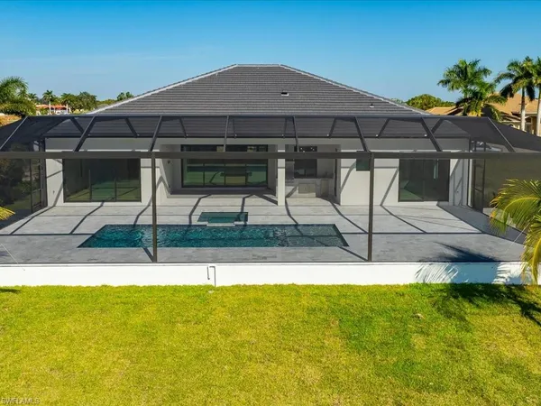a view of a backyard with swimming pool