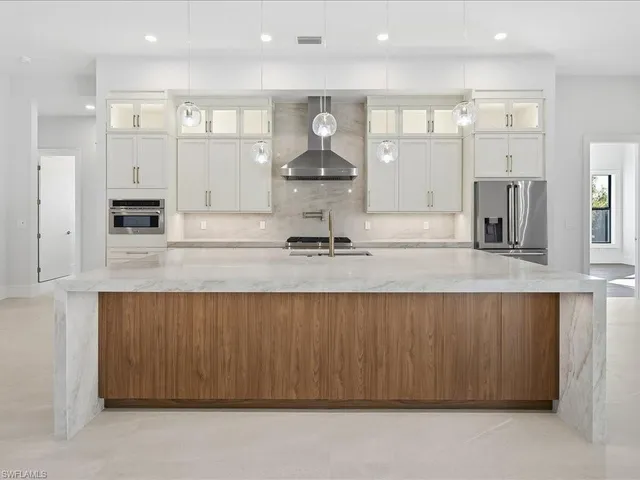 a kitchen with stainless steel appliances granite countertop a sink and cabinets