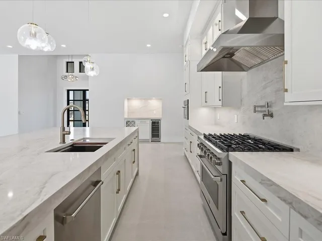 a large white kitchen with a large window