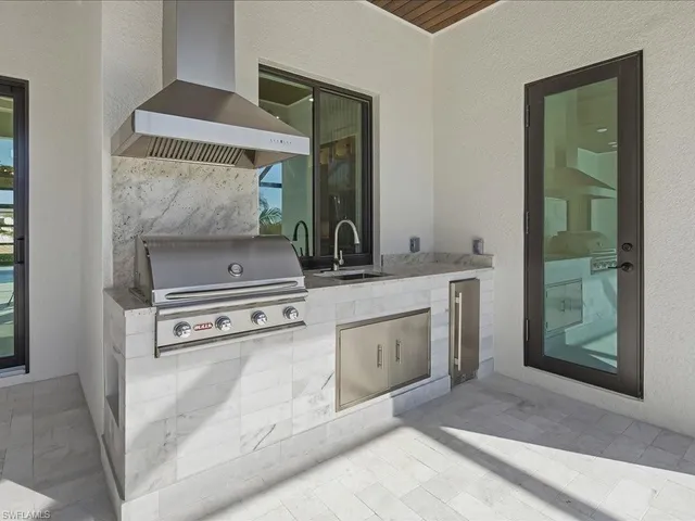 a bedroom with a bed mirror and windows