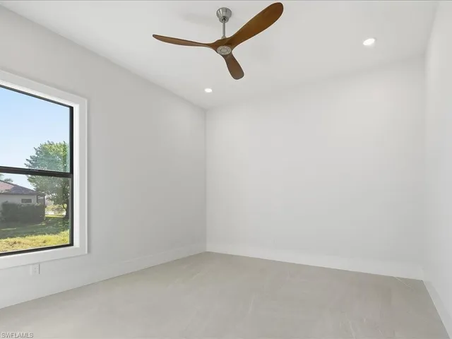 a view of a livingroom with wooden floor and white walls