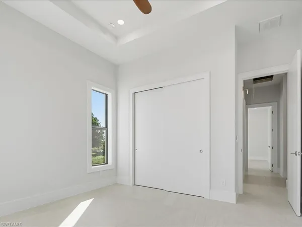 an empty room with windows and closet