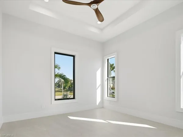an empty room with windows and closet