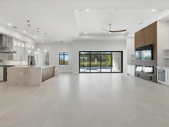 a view of a kitchen with large windows
