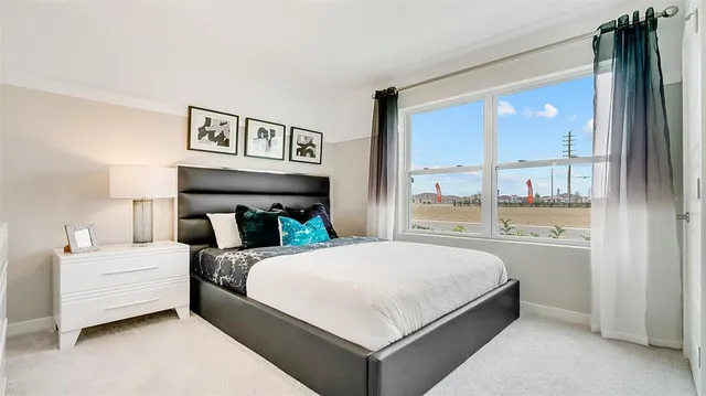 a bedroom with a large bed and a large window