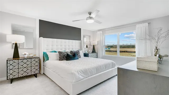a bedroom with a large bed and a chandelier