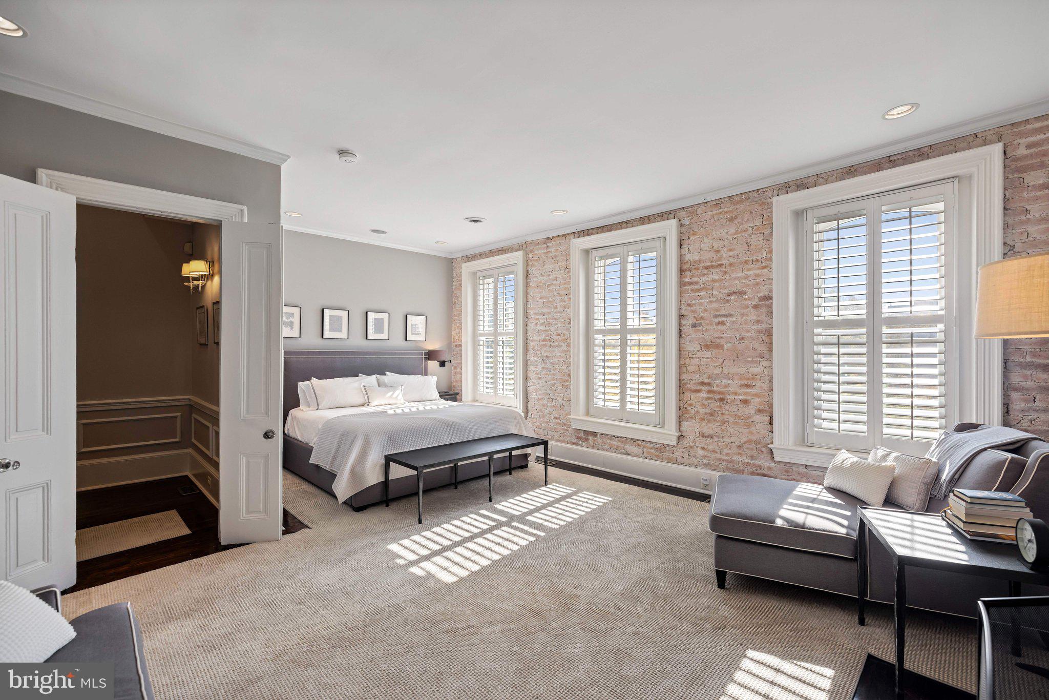 1213 O Street Northwest Washington, DC 20005 - Photo 18 of 29 a spacious bedroom with a bed and a couch