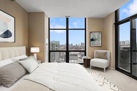 a bedroom with a large bed and a large window