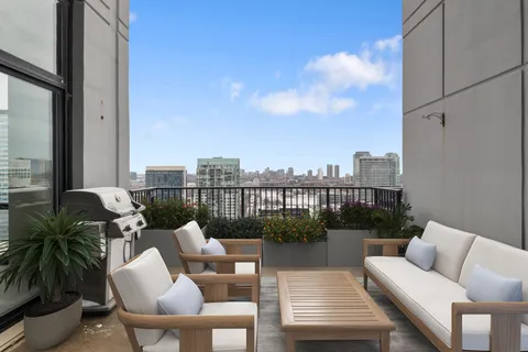 a balcony with furniture and a potted plant