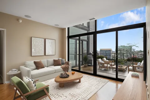 a living room with furniture and a floor to ceiling window