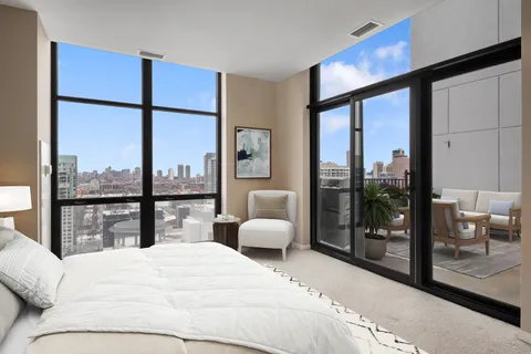 a bedroom with a large bed and a large window