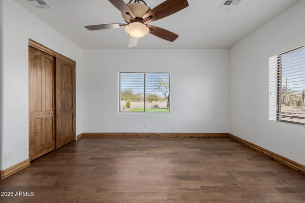 wooden floor in an empty room with a window
