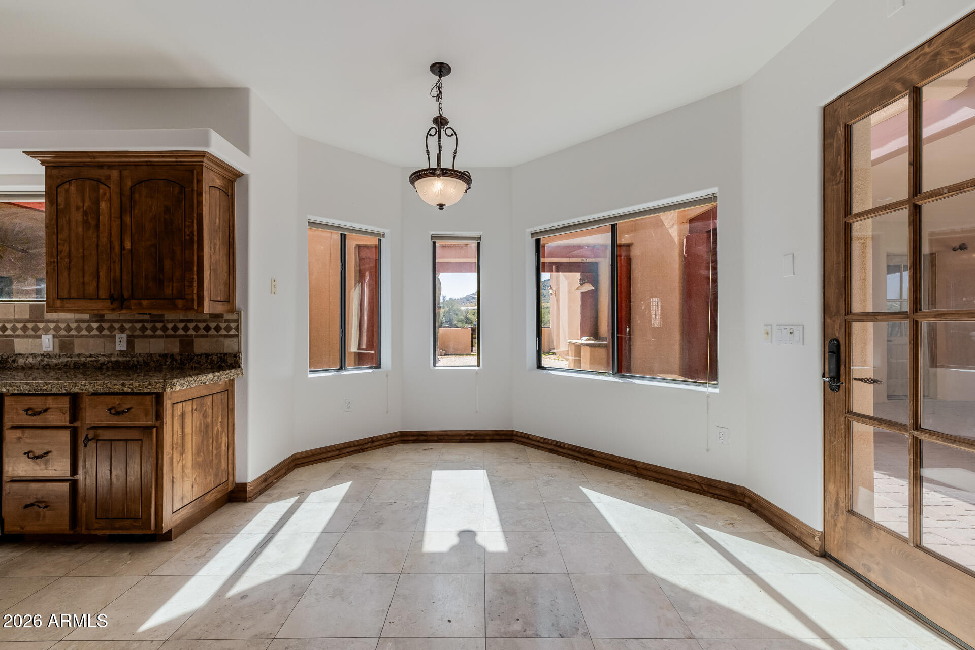 1815 West Maddock Road Phoenix, AZ 85086 - Photo 25 of 71 a view of an empty room with window and kitchen view