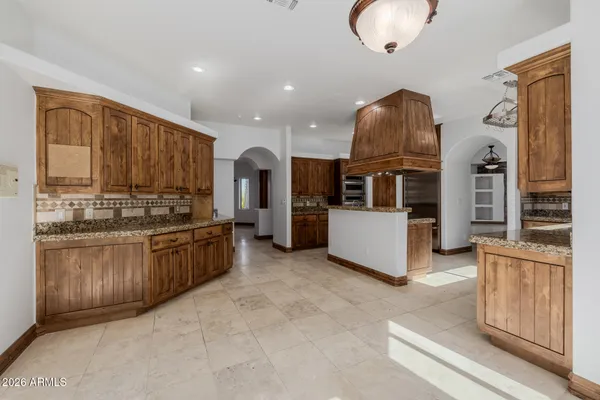 a kitchen with stainless steel appliances granite countertop a stove and a sink
