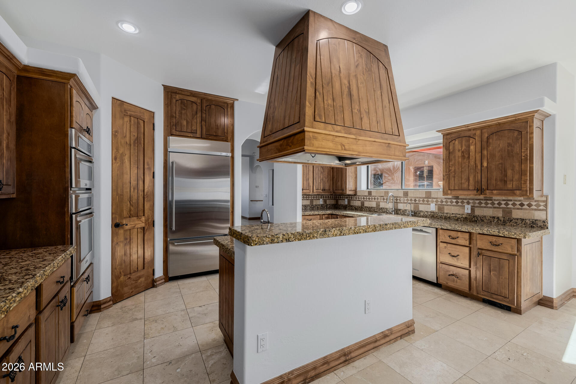 1815 West Maddock Road Phoenix, AZ 85086 - Photo 27 of 71 a kitchen with stainless steel appliances granite countertop a refrigerator and a stove top oven