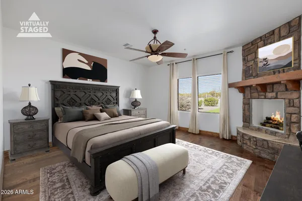 a view of room with hardwood floor and a ceiling fan