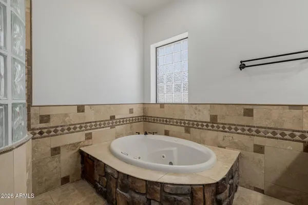 a bathroom with a granite countertop sink a mirror and a shower