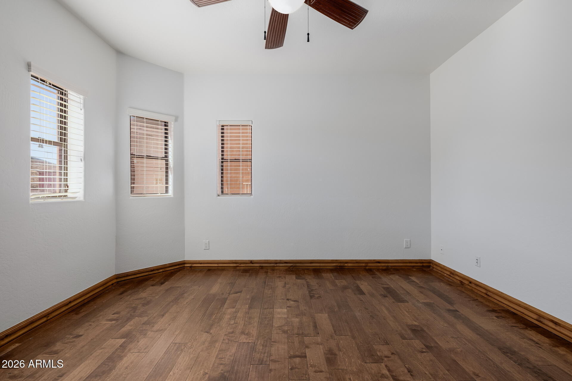 1815 West Maddock Road Phoenix, AZ 85086 - Photo 49 of 71 an empty room with wooden floor cabinet and windows