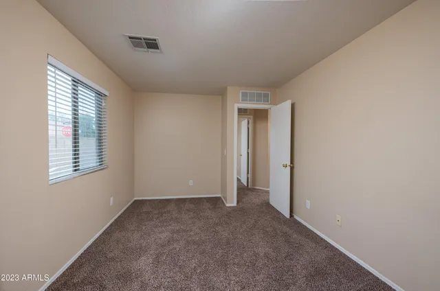 a view of an empty room with a window