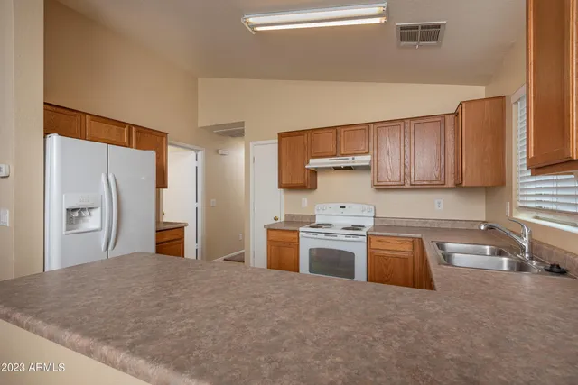 a view of a room with a ceiling fan and window