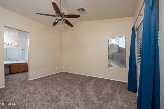 a bathroom with a sink mirror and shower