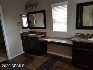 a kitchen with stainless steel appliances granite countertop a sink refrigerator and cabinets