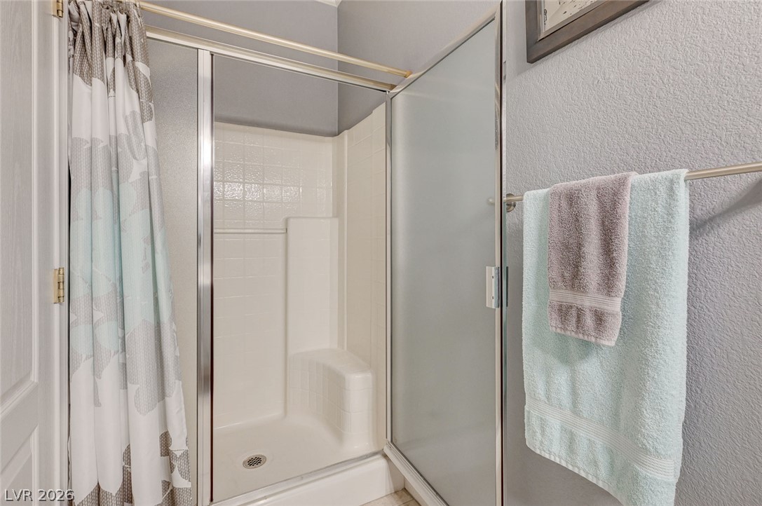1604 Cattle Ranch Place Henderson, NV 89002 - Photo 61 of 99 A streamlined shower stall with a built-in seat offers daily convenience.