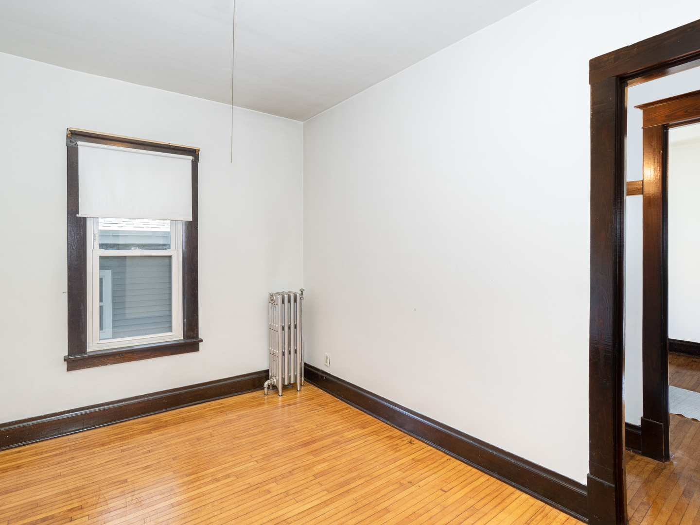 121 Davis Avenue, Unit 1 Rockdale, IL 60436 - Photo 9 of 10 a view of an empty room with wooden floor and a window