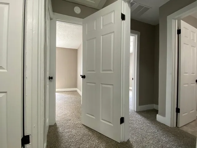 a view of a bathroom with white door