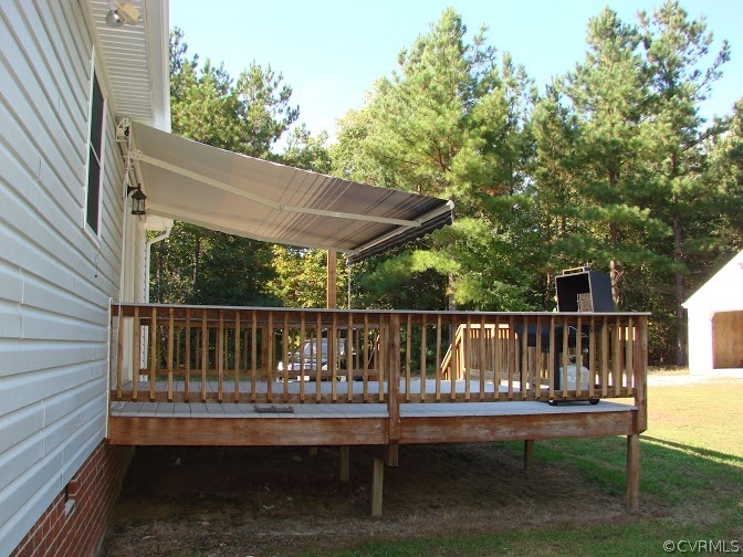16145 Glebe Road Dewitt, VA 23840 - Photo 5 of 15 a balcony with wooden floor table and chairs
