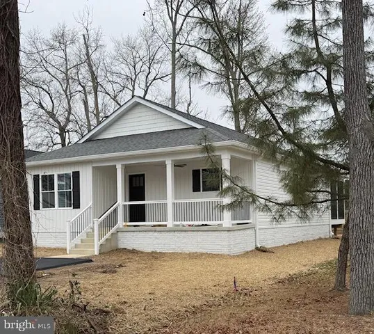 a house that has a tree in front of the house