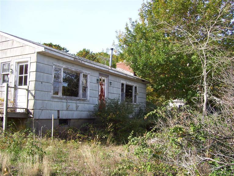 145 Indian Neck Road Wellfleet, MA 02667 - Photo 3 of 5 a view of a house with a yard