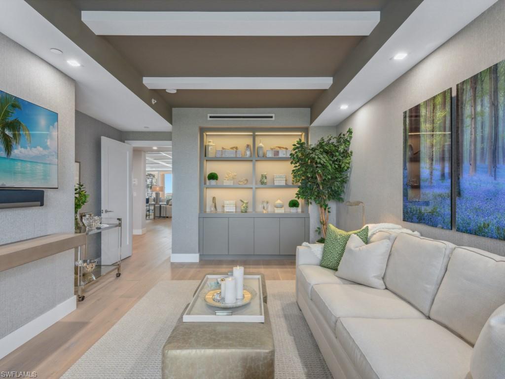 13915 Old Coast Road, Unit 702 Naples, FL 34110 - Photo 15 of 20 Living room featuring wood finished floors, beam ceiling, and recessed lighting