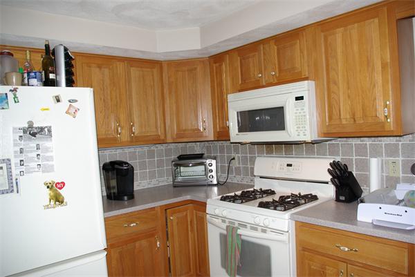 15 Gov Doherty Road Billerica, MA 01821 - Photo 12 of 30 a kitchen with stainless steel appliances a stove a microwave and a refrigerator