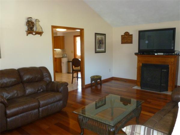 15 Gov Doherty Road Billerica, MA 01821 - Photo 17 of 30 a living room with furniture a flat screen tv and a fireplace