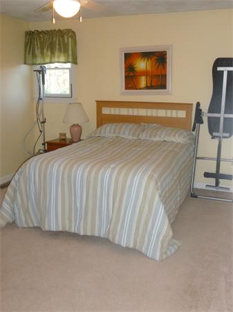 15 Gov Doherty Road Billerica, MA 01821 - Photo 25 of 30 a bedroom with a bed and a painting on the wall
