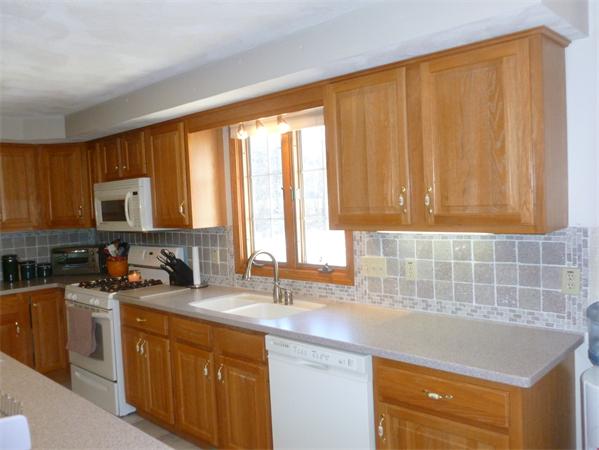 15 Gov Doherty Road Billerica, MA 01821 - Photo 7 of 30 a kitchen with stainless steel appliances a sink stove and cabinets