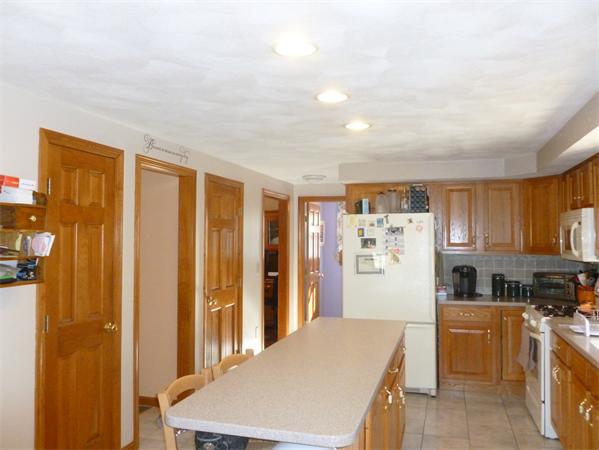 15 Gov Doherty Road Billerica, MA 01821 - Photo 9 of 30 a kitchen with stainless steel appliances granite countertop a refrigerator a oven a sink dishwasher and white cabinets with wooden floor