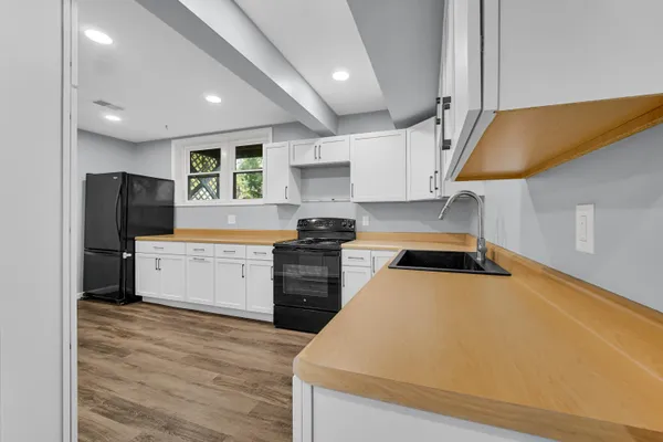 a kitchen with a stove a refrigerator and a sink