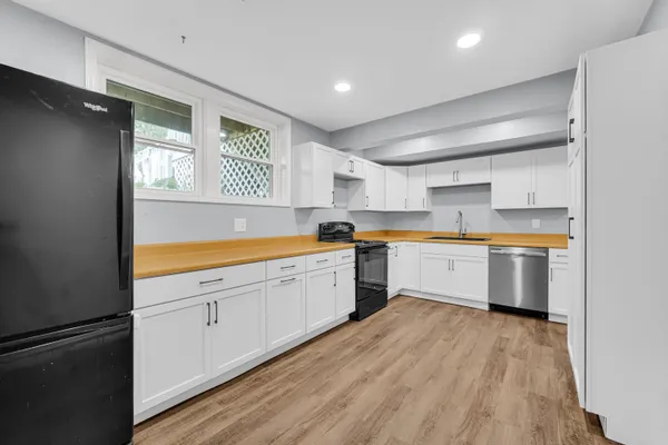 a kitchen with a cabinets and wooden floor